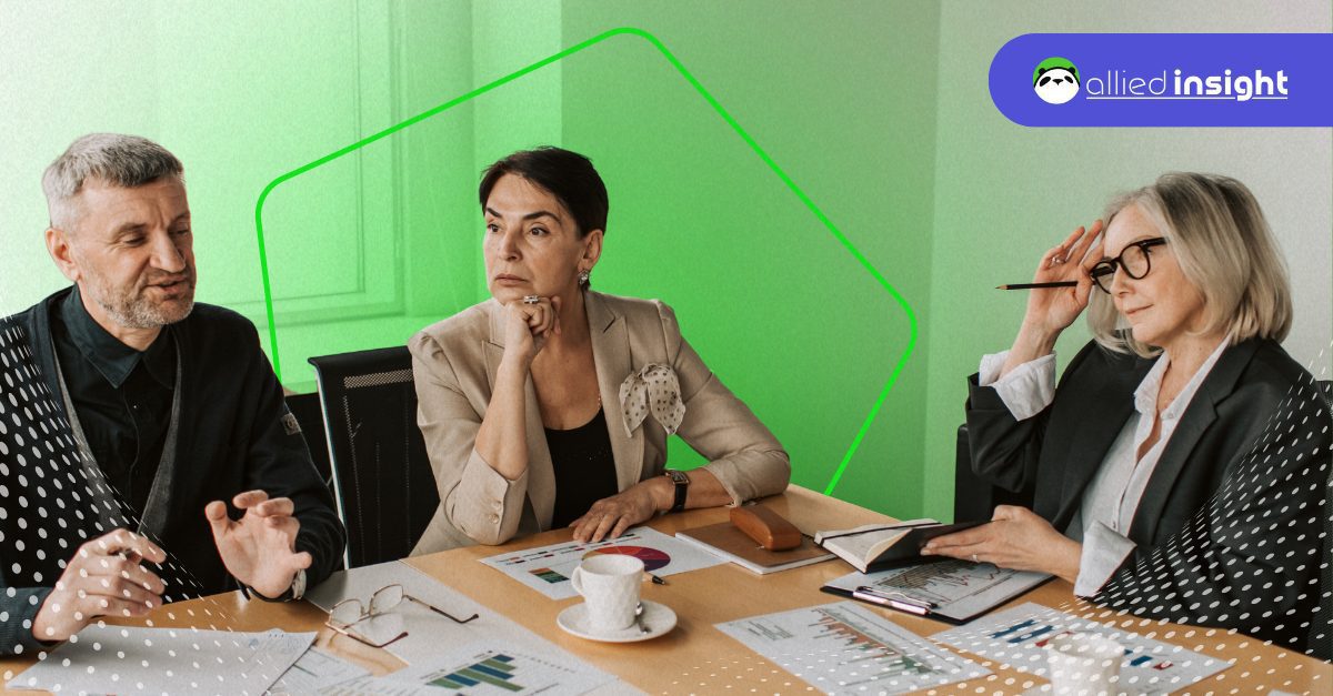 Three business professionals in a meeting reviewing SEO and pipeline performance reports and charts on the table